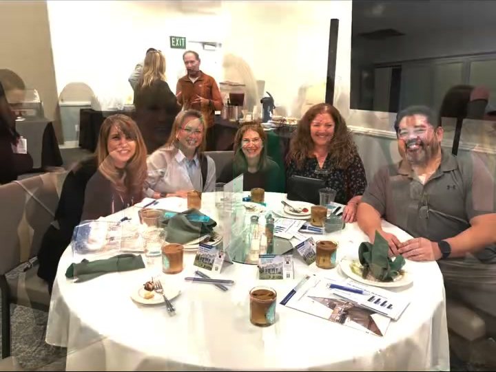 Members at a table during the quarterly education lunch
